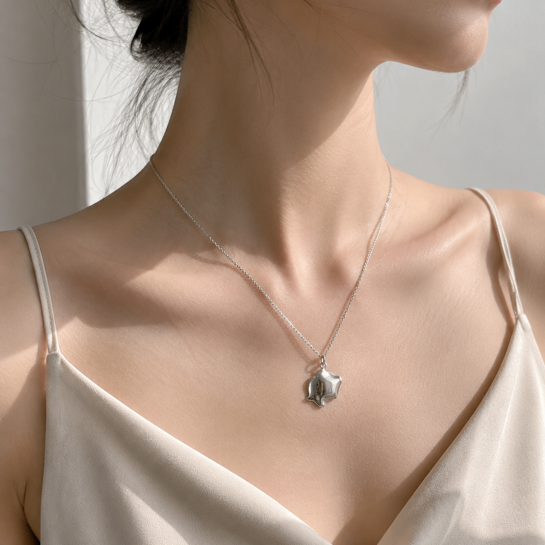 Pig Flow Pendant worn on model